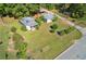 Aerial view showing an overgrown lot with two buildings nestled amongst foliage and adjacent streets at 21 Elm St, Hampton, GA 30228