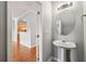 Stylish half bathroom with a modern pedestal sink, updated fixtures, and neutral decor at 7177 Fringe Flower Dr, Austell, GA 30168