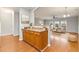 Inviting entryway with hardwood floors, wood cabinets and seamless access to the living area at 7177 Fringe Flower Dr, Austell, GA 30168