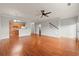Spacious living room showcasing hardwood floors, neutral paint, and open layout to the kitchen at 7177 Fringe Flower Dr, Austell, GA 30168