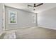 Empty bedroom featuring new carpet, base trim, and two windows at 1382 Bennett Rd, Grayson, GA 30017