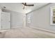 Bedroom featuring neutral carpet, a ceiling fan, and a view from the window at 1382 Bennett Rd, Grayson, GA 30017