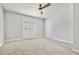 Bright bedroom with ceiling fan, carpet flooring and double doors to the backyard at 1382 Bennett Rd, Grayson, GA 30017