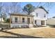 Charming two-story home with a cozy covered porch and modern, white brick and wood detailing at 1382 Bennett Rd, Grayson, GA 30017