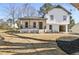 Charming two-story home with a cozy covered porch and modern, white brick and wood detailing at 1382 Bennett Rd, Grayson, GA 30017