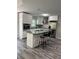 Modern kitchen featuring white cabinets, stainless steel appliances, and an island with granite countertops at 1382 Bennett Rd, Grayson, GA 30017