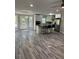 Bright open-concept living room featuring hardwood floors and access to the kitchen and outdoor patio at 1382 Bennett Rd, Grayson, GA 30017