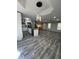 Open-concept living room with hardwood floors, modern lighting, and ample space for entertaining at 1382 Bennett Rd, Grayson, GA 30017