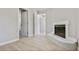 Bright living room featuring a charming white brick fireplace and ample natural light from the window at 1382 Bennett Rd, Grayson, GA 30017
