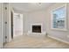 Bright living room featuring a charming white brick fireplace and ample natural light from the window at 1382 Bennett Rd, Grayson, GA 30017