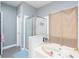 Bathroom featuring a shower with a glass door and a soaking tub at 2221 Baker Carter Dr, Loganville, GA 30052