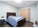 Bedroom with wood floor and window with curtain at 2221 Baker Carter Dr, Loganville, GA 30052