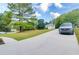 Long concrete driveway leading to a home obscured by trees, with a truck parked in the foreground at 2221 Baker Carter Dr, Loganville, GA 30052