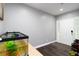 Minimalist entryway with dark wood floors, gray walls, an aquarium, and a white front door at 2221 Baker Carter Dr, Loganville, GA 30052