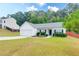 Charming single-story home with a well-manicured lawn, attached garage, and inviting front entrance at 2221 Baker Carter Dr, Loganville, GA 30052