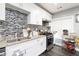 Modern kitchen with white cabinets, granite countertops, and stylish backsplash at 2221 Baker Carter Dr, Loganville, GA 30052