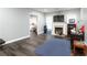 Cozy living room with dark wood floors, a fireplace, a TV, and an open layout at 2221 Baker Carter Dr, Loganville, GA 30052