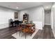 Versatile living space with dark wood floors, a dining area, gray walls, and lots of natural light at 2221 Baker Carter Dr, Loganville, GA 30052