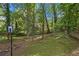 Large backyard features a basketball hoop, mature trees, and a grassy area for outdoor activities and enjoyment at 2950 Springfield Sw Ct, College Park, GA 30349