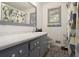 Modern bathroom with a gray vanity, toilet, and shower with patterned curtain at 2950 Springfield Sw Ct, College Park, GA 30349