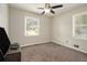 Cozy bedroom with neutral paint, carpet, and natural light streaming through the windows at 2950 Springfield Sw Ct, College Park, GA 30349