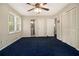 Spacious bedroom with blue carpet, ceiling fan and natural light from the window at 2950 Springfield Sw Ct, College Park, GA 30349