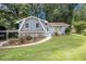 Charming two-story home with a well-maintained lawn, flowering bushes, and beautiful landscaping at 2950 Springfield Sw Ct, College Park, GA 30349