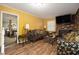 Bright living room with modern furniture, brick fireplace, and a large TV at 2950 Springfield Sw Ct, College Park, GA 30349