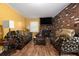 The cozy living room features wood floors, and brick accents for a stylish look at 2950 Springfield Sw Ct, College Park, GA 30349