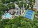 Aerial photo highlighting the pool, clubhouse, tennis courts, and parking nestled in a wooded community at 337 Spotted Ridge Cir, Woodstock, GA 30188