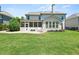 Spacious backyard with a patio area, white furniture, and a well-maintained lawn at 337 Spotted Ridge Cir, Woodstock, GA 30188