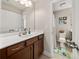Bathroom with a single sink vanity and view of the toilet and tub at 337 Spotted Ridge Cir, Woodstock, GA 30188