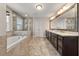 Luxurious bathroom featuring dual sinks, a soaking tub, and a separate glass enclosed shower at 337 Spotted Ridge Cir, Woodstock, GA 30188