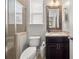 Well-appointed bathroom with granite countertop, dark wood vanity, and tiled glass shower at 337 Spotted Ridge Cir, Woodstock, GA 30188