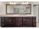Bathroom vanity with double sinks, granite countertop, and large mirror reflecting the tiled shower at 337 Spotted Ridge Cir, Woodstock, GA 30188