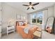 Cozy bedroom features a comfortable queen-sized bed, neutral decor, and natural light from the window at 337 Spotted Ridge Cir, Woodstock, GA 30188