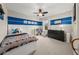 Bedroom with blue stripe accent wall, queen bed, dresser, and ceiling fan at 337 Spotted Ridge Cir, Woodstock, GA 30188