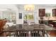 Open dining area features a large table, views to the sunroom and kitchen, and stylish decor at 337 Spotted Ridge Cir, Woodstock, GA 30188