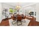 Elegant dining room featuring hardwood floors, modern chandelier, and access to an office space at 337 Spotted Ridge Cir, Woodstock, GA 30188