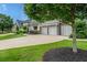 Spacious driveway leading to a three-car garage, enhanced by well-manicured lawn and tasteful landscaping at 337 Spotted Ridge Cir, Woodstock, GA 30188