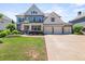 Charming two-story home featuring a three-car garage, manicured lawn and lush landscaping at 337 Spotted Ridge Cir, Woodstock, GA 30188