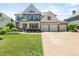 Charming two-story home with a manicured lawn, a three-car garage, and classic American design at 337 Spotted Ridge Cir, Woodstock, GA 30188