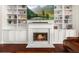 Cozy living room featuring a fireplace with built-in bookshelves and cabinets at 337 Spotted Ridge Cir, Woodstock, GA 30188
