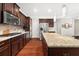 Spacious kitchen boasts stainless steel appliances, granite countertops, and dark wood cabinets at 337 Spotted Ridge Cir, Woodstock, GA 30188