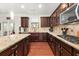Well-equipped kitchen with granite countertops, dark wood cabinets, and stainless steel appliances at 337 Spotted Ridge Cir, Woodstock, GA 30188
