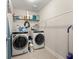 Laundry room with white washer and dryer, shelving, and storage space at 337 Spotted Ridge Cir, Woodstock, GA 30188