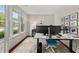 Bright home office with hardwood floors, modern desk setup, and an abundance of natural light at 337 Spotted Ridge Cir, Woodstock, GA 30188
