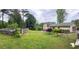 Lush backyard featuring an in-ground pool, mature trees, and a deck, perfect for entertaining at 792 Oneta Dr, Norcross, GA 30093