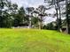 Expansive backyard with a lush lawn, mature trees, and a decorative brick fence, offering a serene outdoor setting at 792 Oneta Dr, Norcross, GA 30093