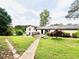 Serene backyard, accented by a lush lawn and mature trees, offering privacy and outdoor space at 792 Oneta Dr, Norcross, GA 30093